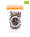 Clearly organic Chaga capsules in a bottle with a brown label and clear cap on a wooden surface.