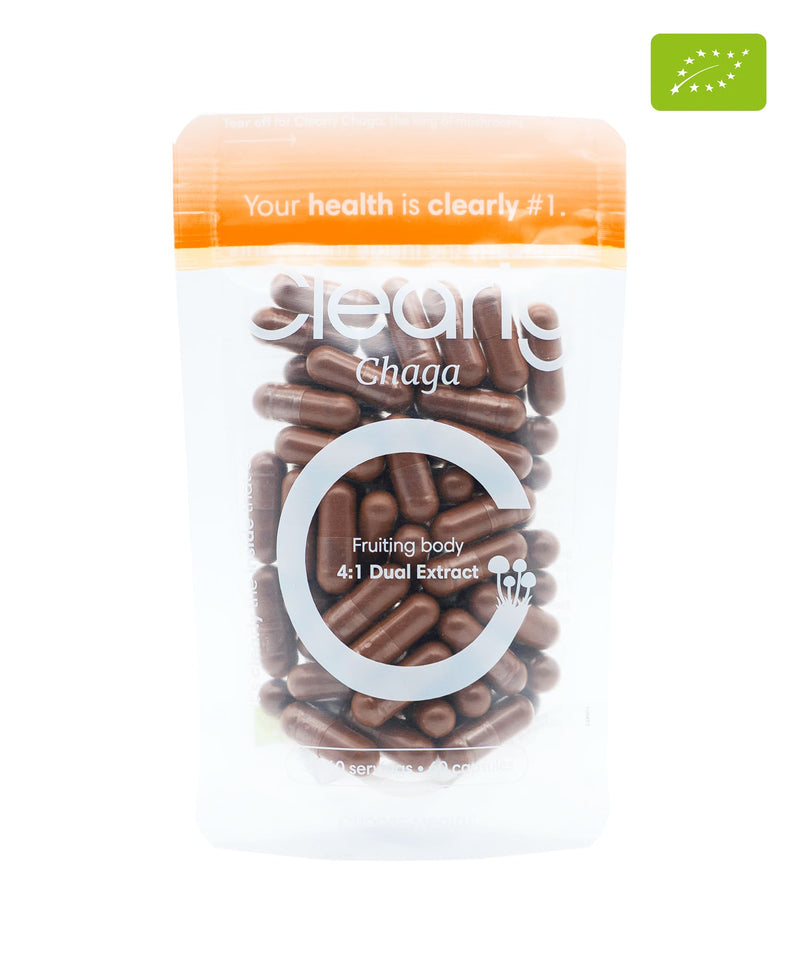 Clearly organic Chaga capsules in a bottle, showing the dietary supplement packaging with capsules inside.